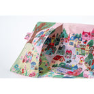 An outside pocket of a planner cover on a white background, printed with a whimsical multicolor village scene featuring houses, trees, flowers, and small characters.
