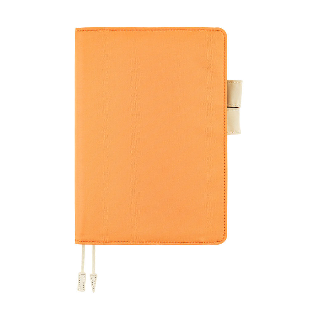 Pastel orange colored Hobonichi Techo cover with contrast ivory white pen loops, and two ribbon bookmarks with tabs shown on a plain white background.
