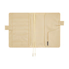 Ivory interior of a Hobonichi Techo cover laid open flat on a white background, showing multiple card and storage pockets, pen loops, and two ribbon bookmarks.