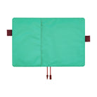 Turquoise Hobonichi Techo cover laid open flat on a white background, showing brown red pen loops and two ribbon bookmarks.