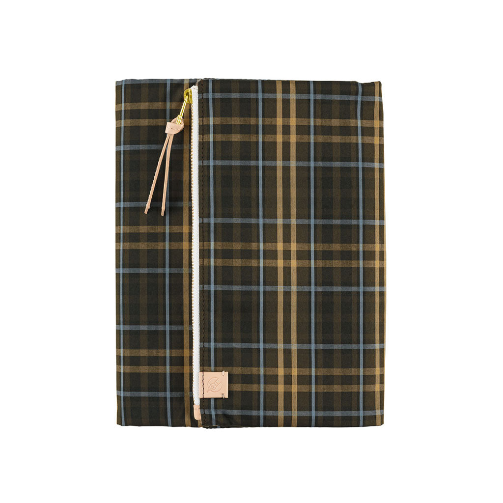 A zippered fabric Hobonichi Techo cover featuring a plaid pattern with beige and light blue lines on a dark brown fabric  with a light tan leather pull tab and a small matching leather label.