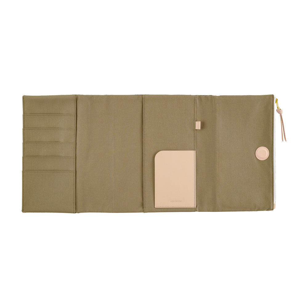 The interior of a Hobonichi Techo cover featuring card slots, a central slip pocket, and a beige leather loop, shown against a plain white background.