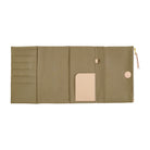 The interior of a Hobonichi Techo cover featuring card slots, a central slip pocket, and a beige leather loop, shown against a plain white background.