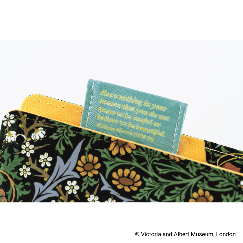 Close-up of a fabric pen loop with a printed William Morris quote that says, "Have nothing in your houses that you do not know to be useful or believe to be beautiful."