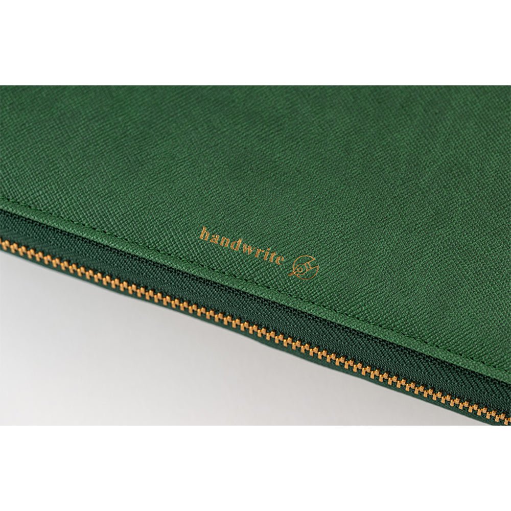 A green-colored Hobonichi Techo zippered cover featuring a gold 'handwrite' logo.