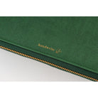A green-colored Hobonichi Techo zippered cover featuring a gold 'handwrite' logo.