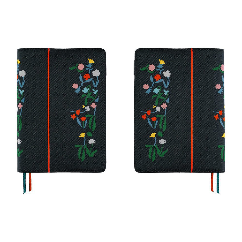 A side by side view of a Hobonichi Techo navy planner cover with colorful embroidered flowers, a vertical red stripe, and ribbon bookmarks in blue and red.