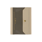 A slim rectangular document holder or folder with a dark taupe-brown front panel and a beige flap closure, featuring a small gold snap button and gold printed text on the left side, shown on a plain white background.