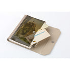 A beige and brown notebook cover shown open on a white background, with a printed card partially inserted.