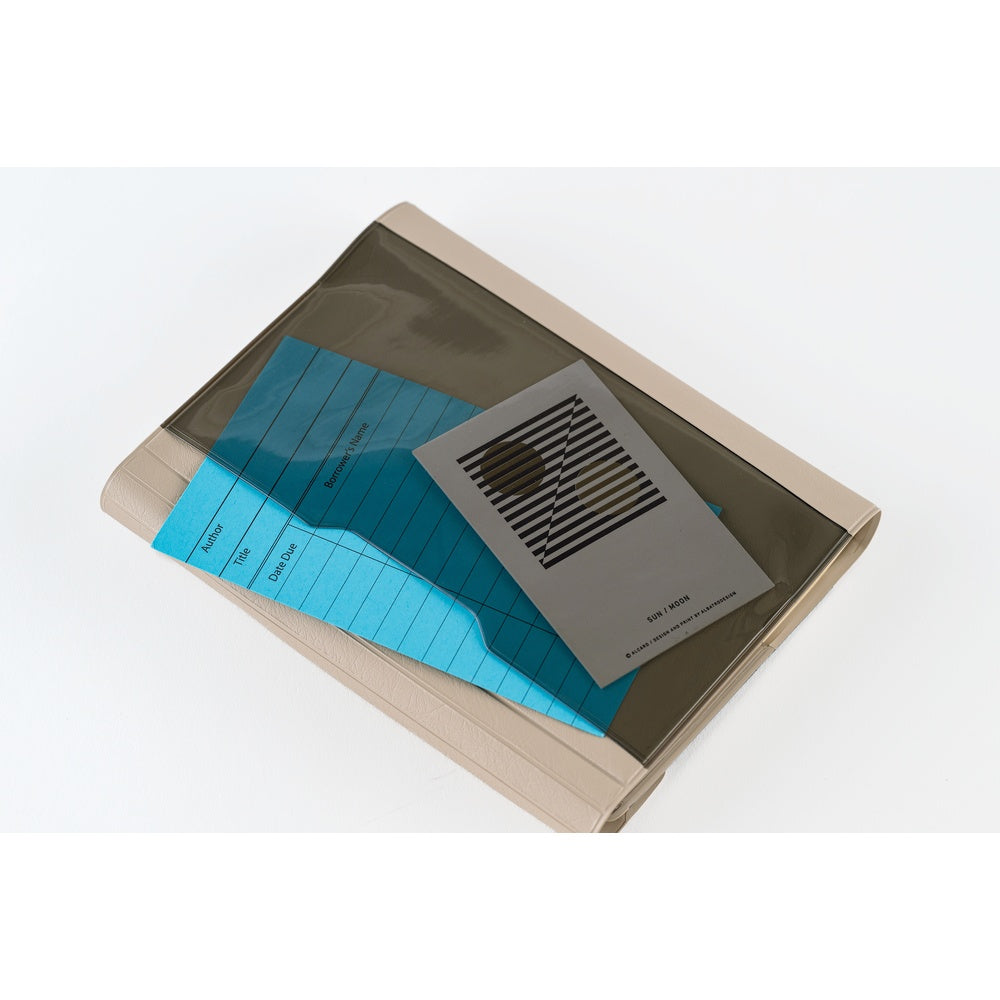 A translucent dark gray plastic document pouch with a beige backing, holding a bright blue lined card and a gray identification badge, shown on a white background.