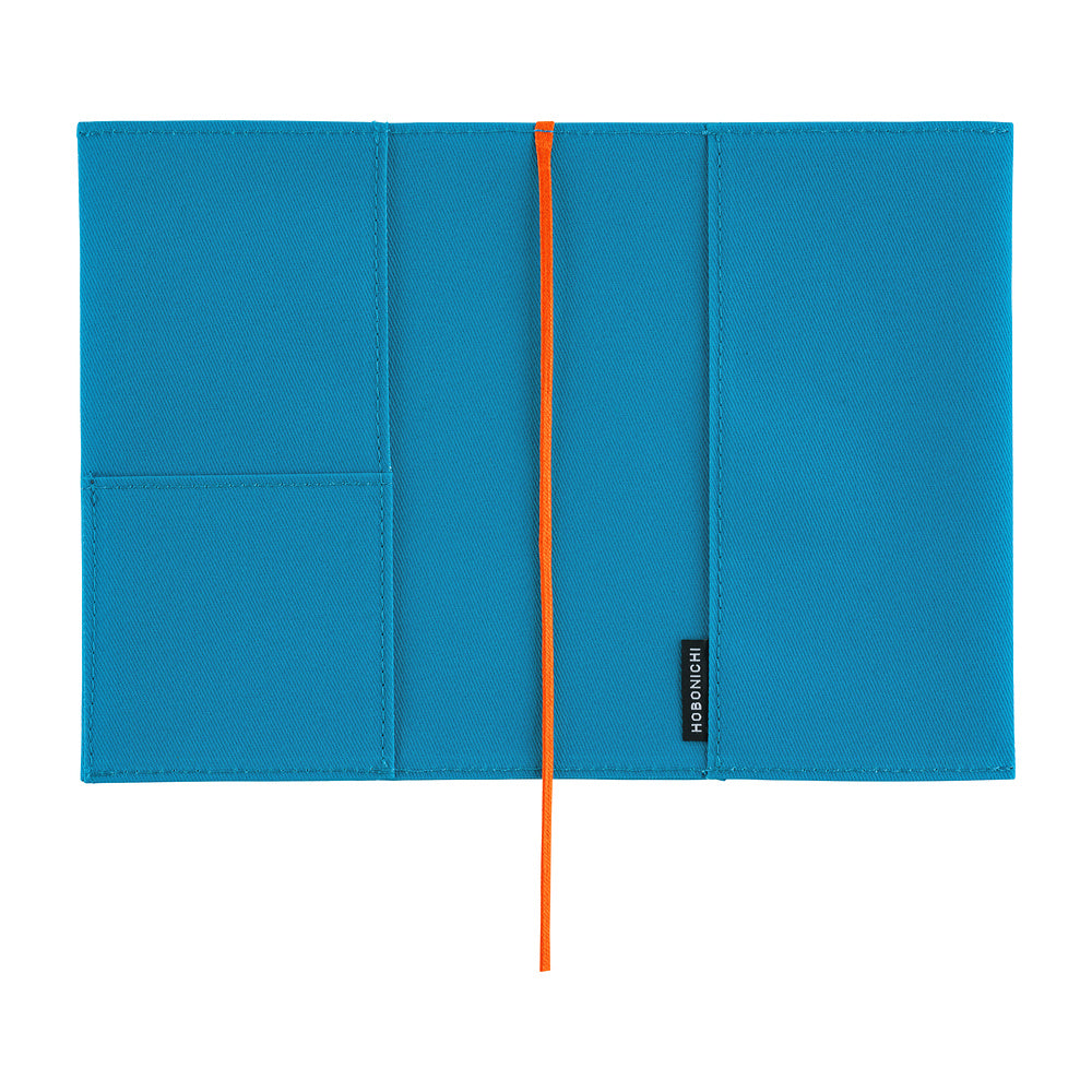 A bright blue notebook cover with a vertical orange elastic closure and a small black brand tag reading 'Hobonichi' on the right side, shown flat against a white background.