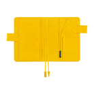 A bright yellow notebook cover with multiple card slots, a pocket, and drawstring closure, shown open on a plain white background.