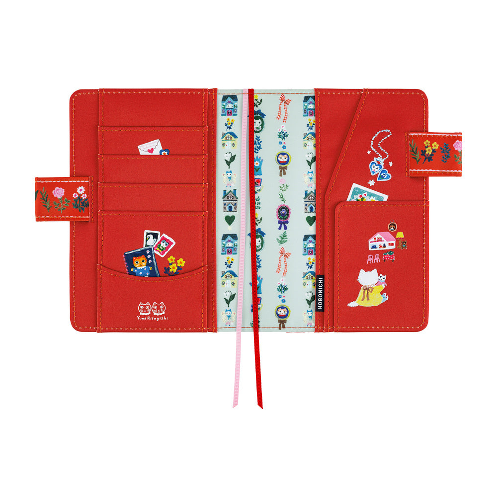 A red planner organizer cover with multiple card slots, pockets, and decorative stickers, shown open against a white background.