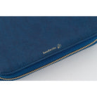 Close-up of a dark blue fabric zippered pouch with a gold zipper and a small gold 'handwrite' logo on the side.