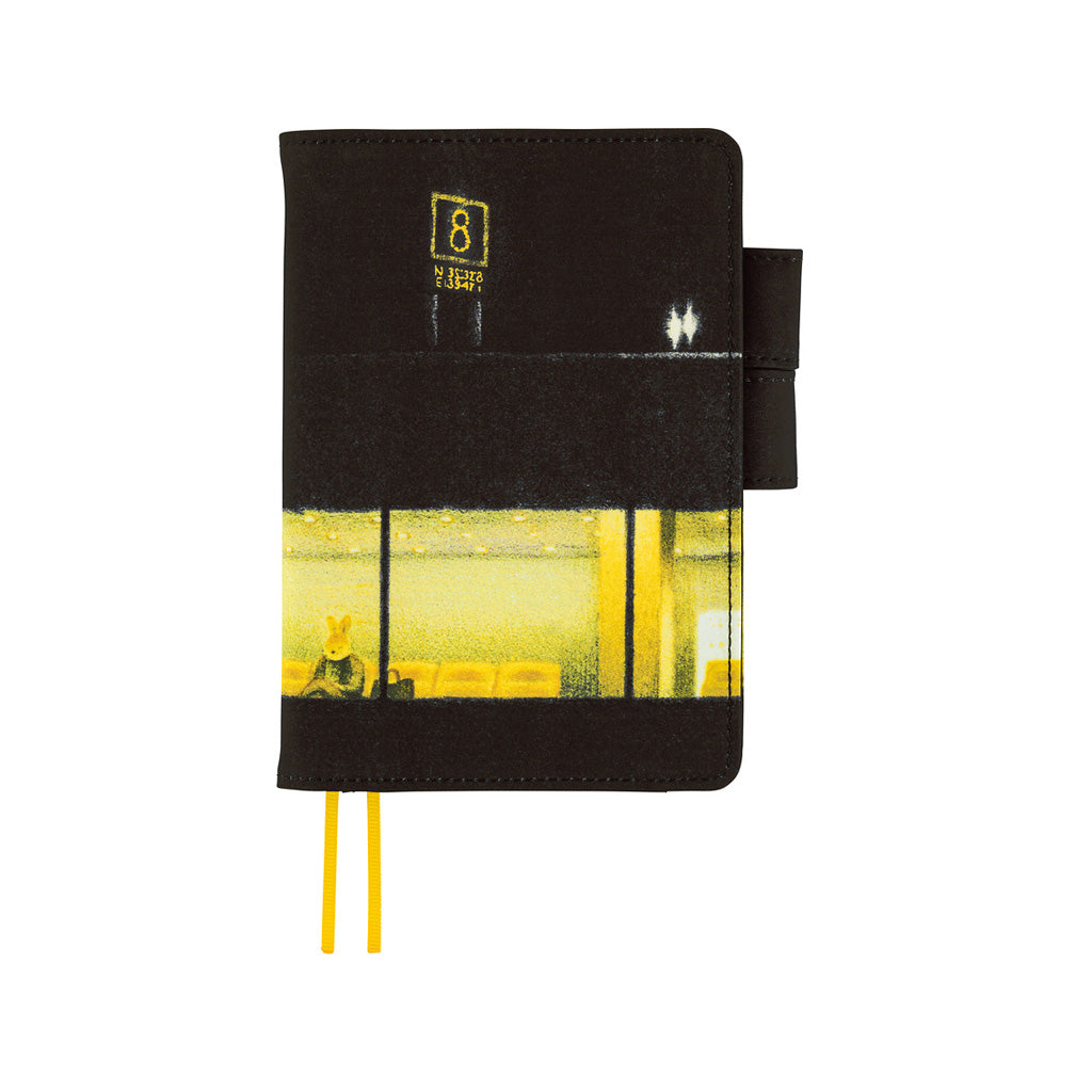 A black hardcover notebook with a printed yellow and black bus window design on the lower half, featuring a yellow bookmark ribbon and a black elastic closure tab, shown on a plain white background.