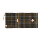 A plaid canvas pouch with a dark green, brown, and gold pattern, featuring a tan zipper pull and a circular tan snap button, shown against a plain white background.