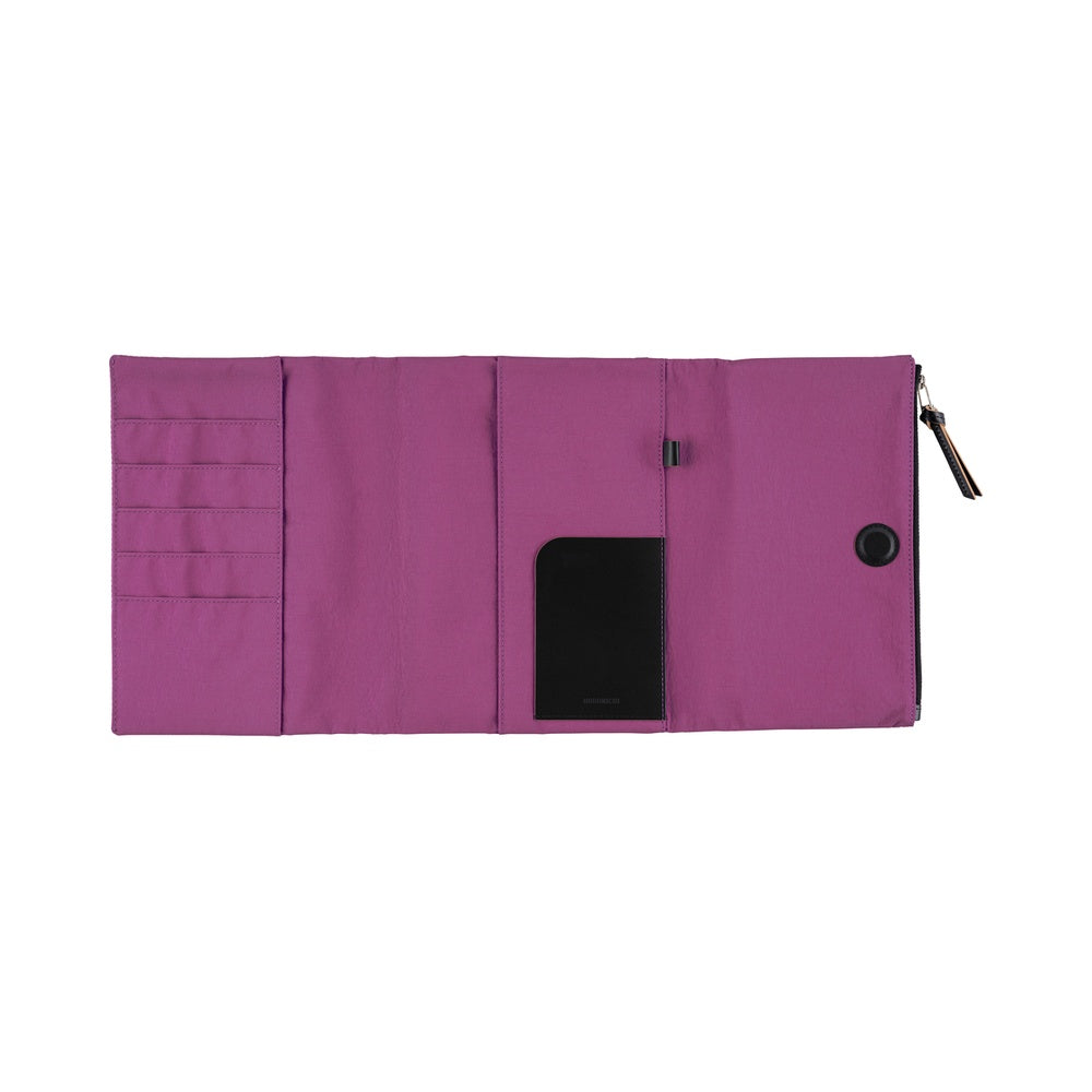 A flat view of a purple Hobonichi Tragen tri-fold inside cover with a vertical zippered pouch, several car pockets, and black zipper pull on a plain white background.