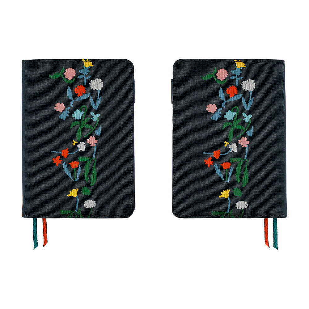 Two black journal covers with colorful embroidered wildflowers, shown side by side on a white background.
