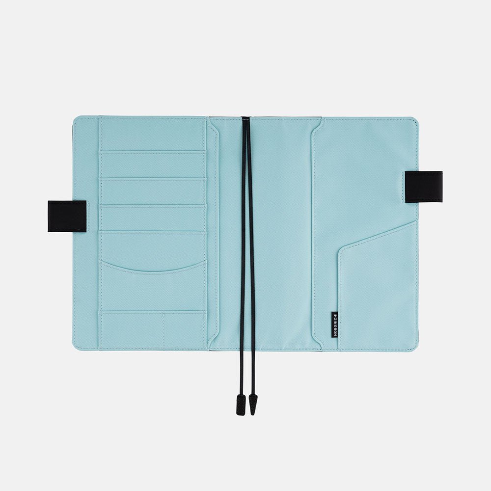 Interior of Hobonichi A5 cover with pen loops and bookmark on white background