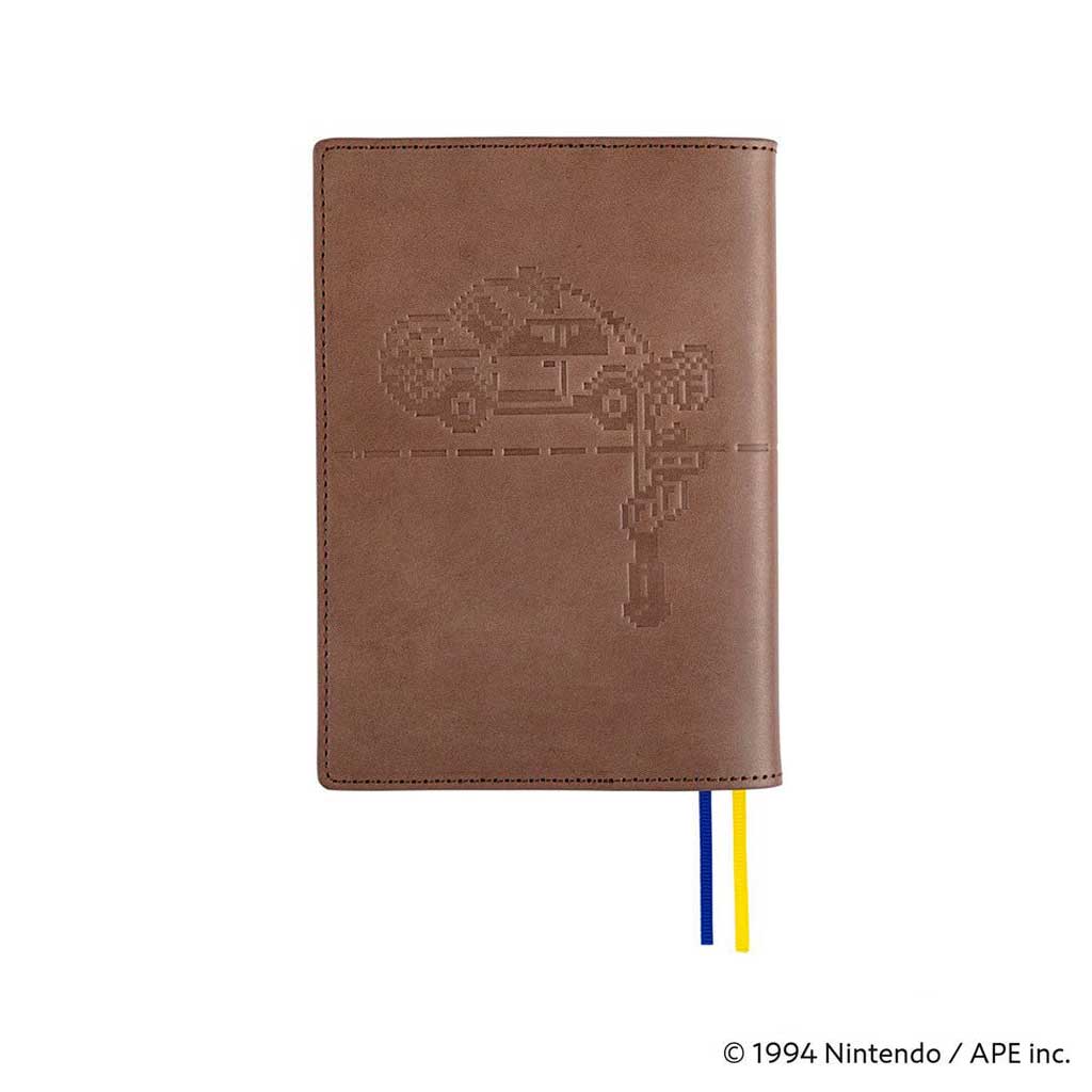 Back of brown leather cover with embossed MOTHER design of pixelated car for Hobonichi Techo A6 planner on white background