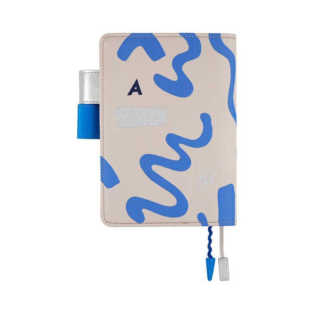 Back of blue and silver abstract design on light gray notebook cover for Hobonichi Techo A6 planner on white background