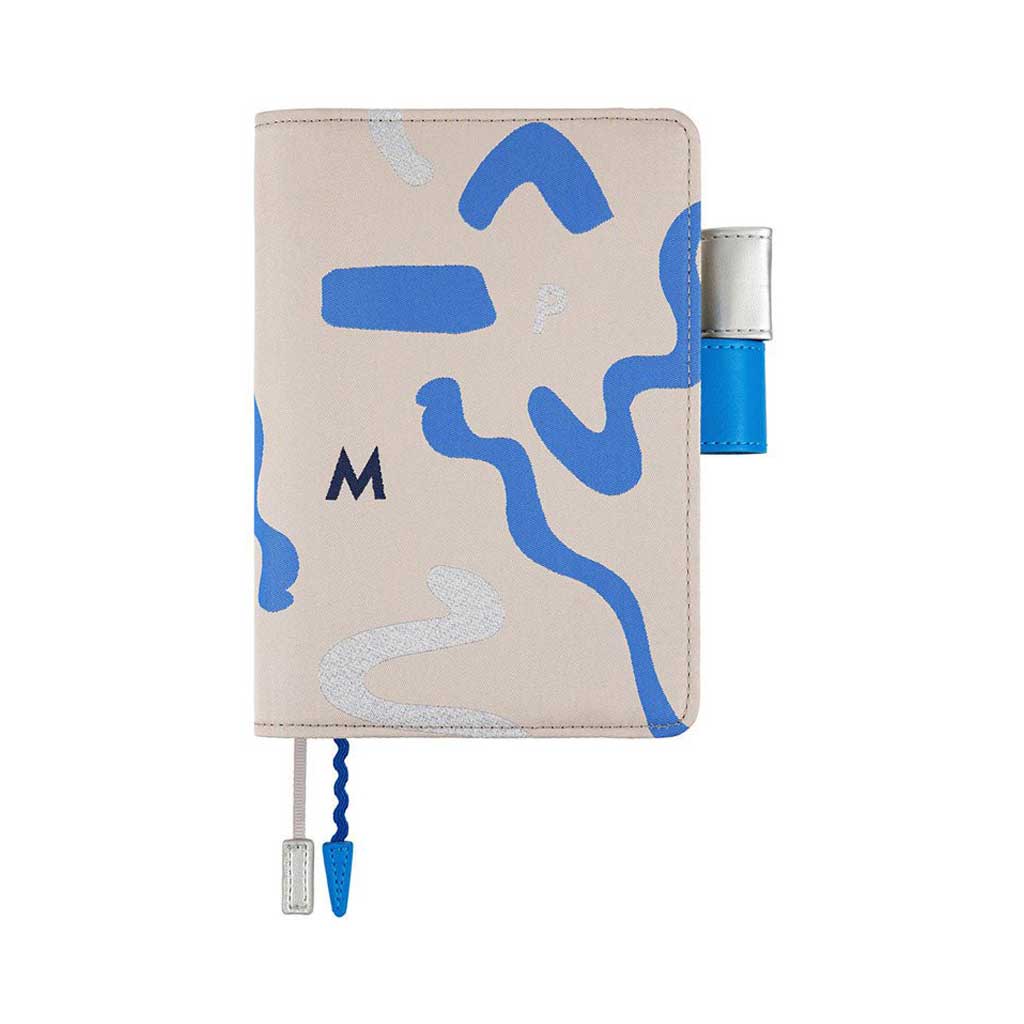Blue and silver abstract design on light gray notebook cover for Hobonichi Techo A6 planner on white background
