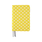 Yellow fabric notebook cover with white triangle pattern for Hobonichi Techo A6 planner on white background