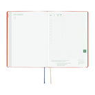 An open 2027 Hobonichi Techo HON hardcover planner showing the November start page beside a daily grid page, with two ribbon bookmarks hanging below on a white background.