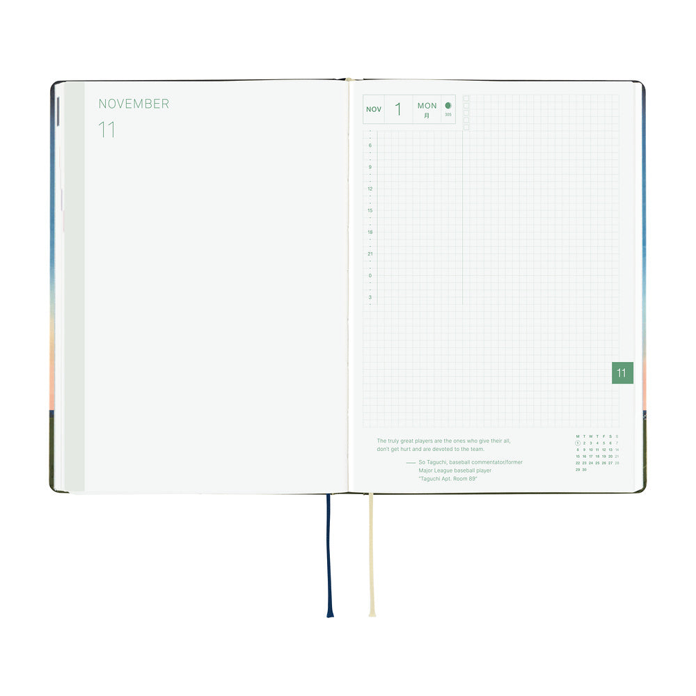 An open 2027 Hobonichi Techo HON hardcover planner showing the November start page beside a daily grid page, with two ribbon bookmarks hanging below on a white background.