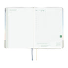An open 2027 Hobonichi Techo HON hardcover planner showing the November start page beside a daily grid page, with two ribbon bookmarks hanging below on a white background.