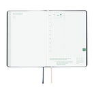 An open 2027 Hobonichi Techo HON hardcover planner showing the November start page beside a daily grid page, with two ribbon bookmarks hanging below on a white background.