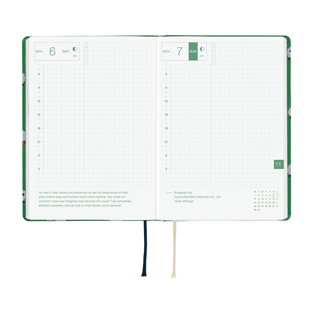 A 2027 Hobonichi HON covered in Bow & Tie fabric woven with a sheep design on a green background