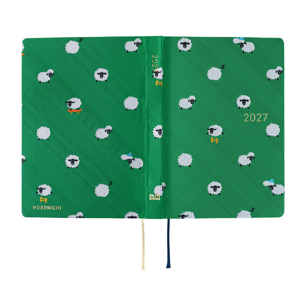 A 2027 Hobonichi HON covered in Bow & Tie fabric woven with a sheep design on a green background
