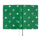 A 2027 Hobonichi HON covered in Bow & Tie fabric woven with a sheep design on a green background