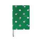 A 2027 Hobonichi HON covered in Bow & Tie fabric woven with a sheep design on a green background