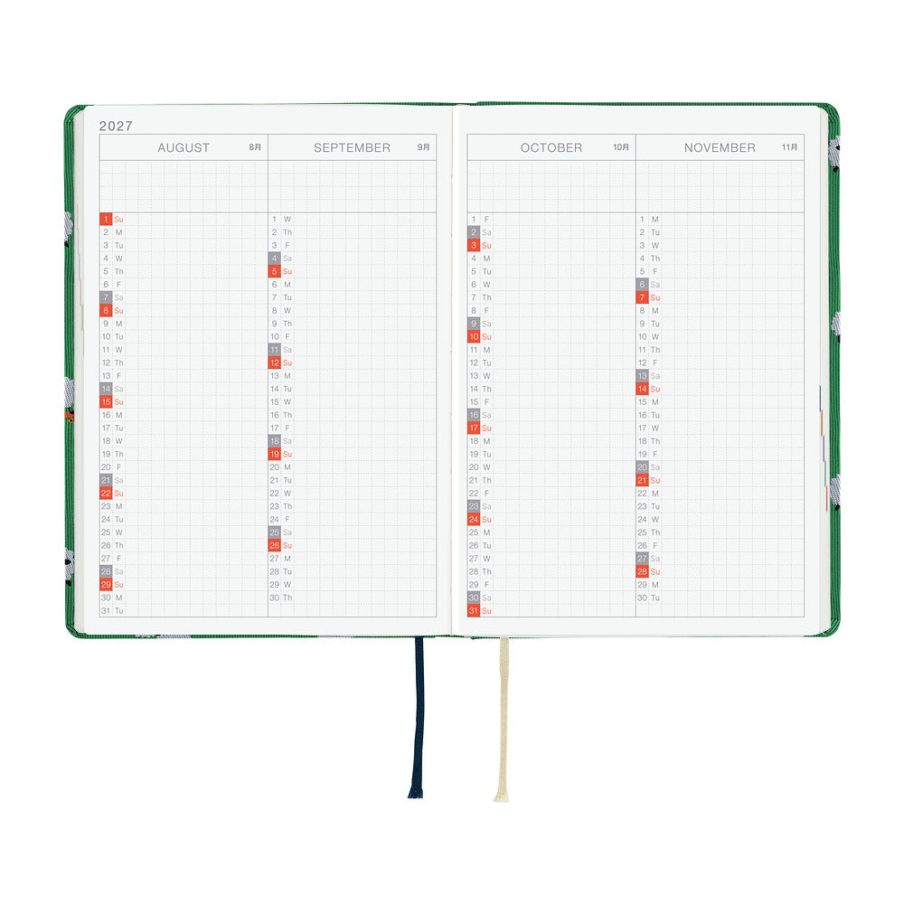 A 2027 Hobonichi HON covered in Bow & Tie fabric woven with a sheep design on a green background