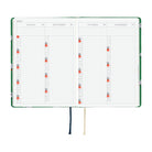 A 2027 Hobonichi HON covered in Bow & Tie fabric woven with a sheep design on a green background
