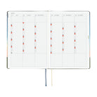 An open planner or journal showing two interior calendar spreads for 2027, with monthly grids, colored page markers, and ribbon bookmarks hanging below on a white background.