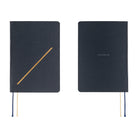 Two dark navy blue hardcover notebooks shown side by side on a white background. The left notebook features a gold diagonal line on the front cover and two ribbon bookmarks in navy and cream.