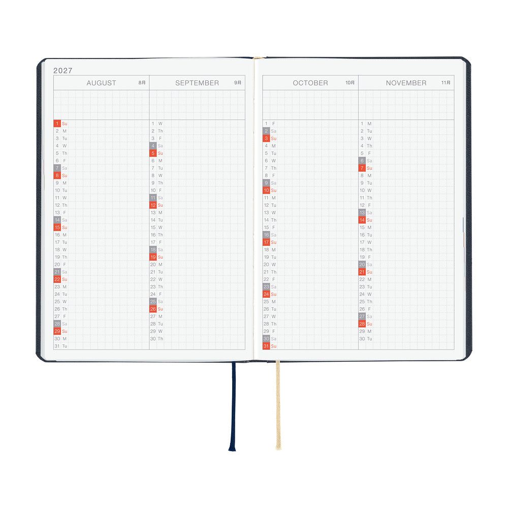 An open planner or calendar showing the months August through November 2027 on two inner pages, with a dark cover edge visible, a navy ribbon bookmark, a cream ribbon bookmark, and small colored date markers. The product is photographed on a plain white background.