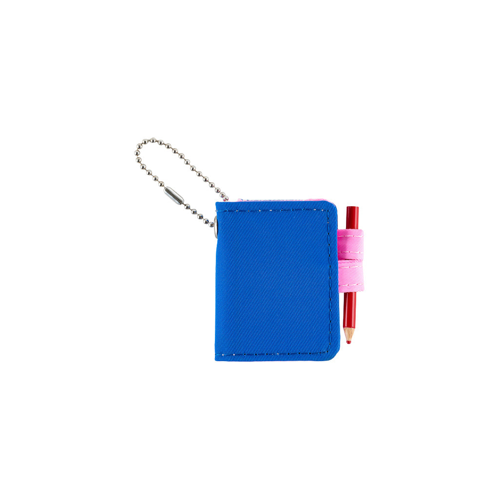 A small blue notebook keychain with a silver ball chain and a pink loop holding a red pencil, shown on a plain white background.