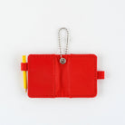 Open small red notebook keychain with a silver ball chain and a red loop holding a yellow pencil shown on a plain white background.