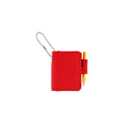 A small red notebook keychain with a silver ball chain and a red loop holding a yellow pencil, shown on a plain white background.