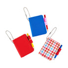 Three small notebook keychains with ball chains on a white background. One is red, one is blue, and one has a red, white, and blue plaid pattern.