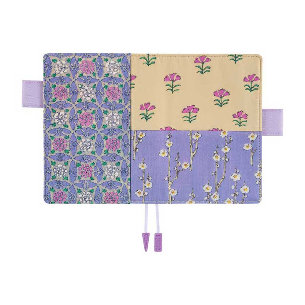 Front and back of Hobonichi Techo A6 Original Unsodo Book in ivory and purple floral cover with purple pen loops laying flat on white background