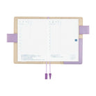 Beige and light purple interior of Hobonichi Techo A6 Original Unsodo cover with planner book open on white background