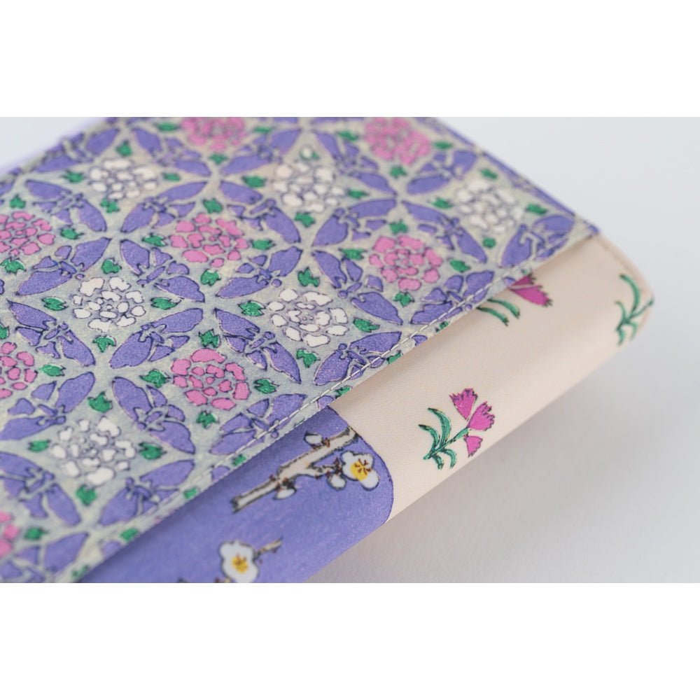 Close up of back of Hobonichi Techo A6 Original Unsodo cover with purple and ivory floral design on white background