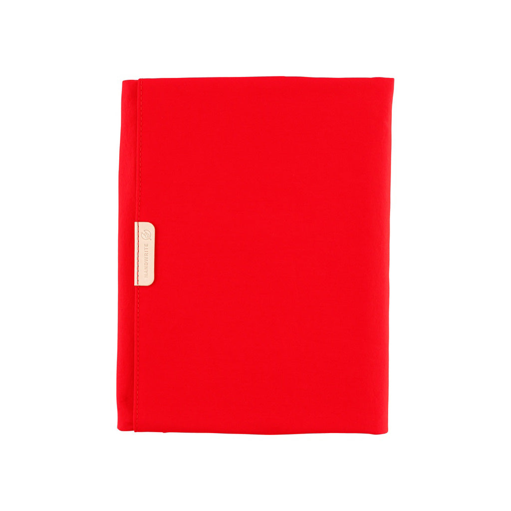 Red fabric Tragen zippered cover for Hobonichi Techo Cousin A5 planner on white background
