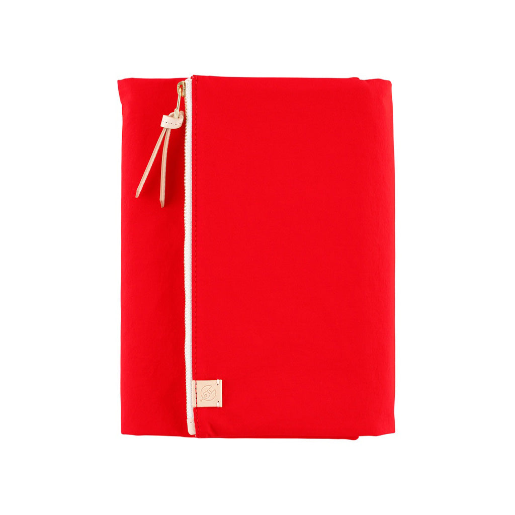 Red fabric Tragen zippered cover for Hobonichi Techo Cousin A5 planner on white background