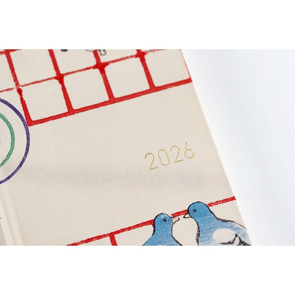 Close up of Hobonichi Techo Weeks Unsodo Spring Start Weeks planner with 2026 year embossed on front cover on white surface